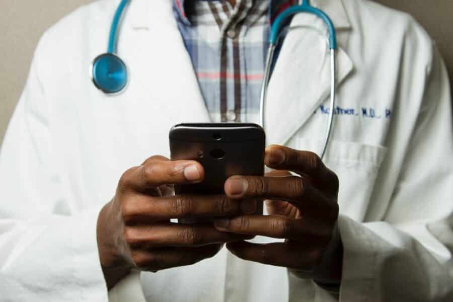 medical doctor holding a cell phone